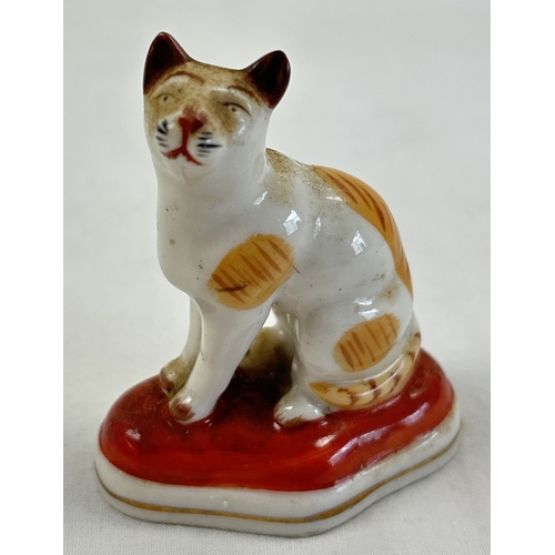 1236 - A collection of antique ceramic figures. To include Staffordshire Lion, Chelsea ginger and white cat... 