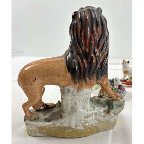 1236 - A collection of antique ceramic figures. To include Staffordshire Lion, Chelsea ginger and white cat... 