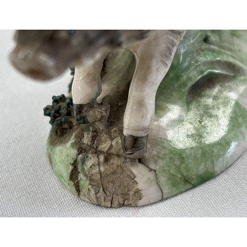 1236 - A collection of antique ceramic figures. To include Staffordshire Lion, Chelsea ginger and white cat... 