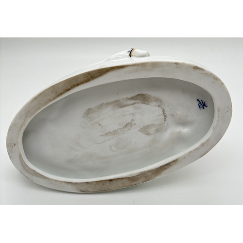 1239 - A German porcelain figure of a girl sitting on the grass with a butterfly in her hair, by Karl Ens V... 