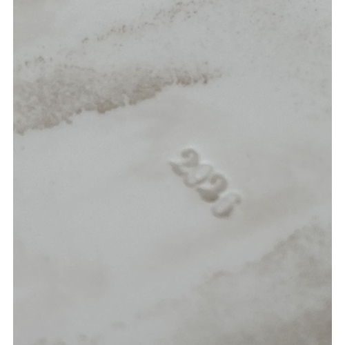 1239 - A German porcelain figure of a girl sitting on the grass with a butterfly in her hair, by Karl Ens V... 