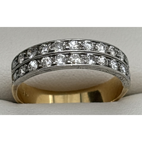 1001 - An 18ct gold and diamond double row half eternity style ring. 24 round cut diamonds totalling approx... 