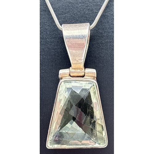 1107 - A silver & green amethyst pendant necklace. Pendant set with a trapeze cut pale green amethyst in a ... 