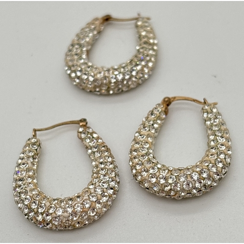 1109 - A pair of 9ct gold disco ball style hoop earrings, set with small round clear crystals. Together wit... 