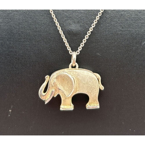 1004 - A brushed silver pendant modelled as an elephant, on an 18