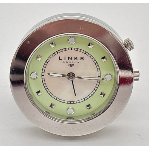 1223 - A small circular travel alarm clock by Links Of London. Stainless steel silver finish case and fixed... 