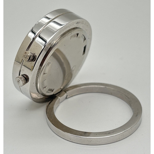 1223 - A small circular travel alarm clock by Links Of London. Stainless steel silver finish case and fixed... 