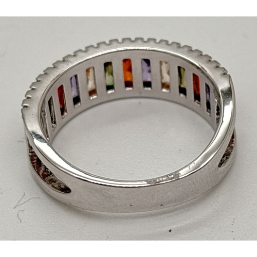 1091 - A rhodium plated cocktail band ring set with Swarovski crystals. Half eternity style ring set with y... 