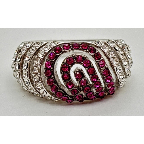 1094 - A rhodium plated dome style cocktail ring set with red and clear Swarovski crystals. 3 rows of red c... 