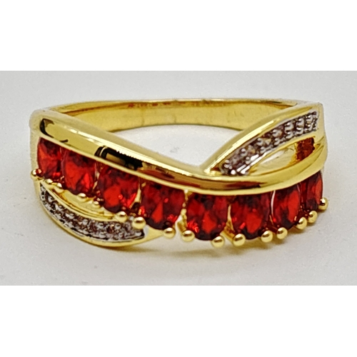 1098 - A yellow gold plated crossover cocktail ring set with round cut red and clear Swarovski crystals. 8 ... 