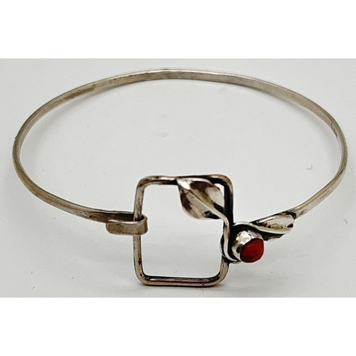 1114 - An Art Nouveau inspired Polish .800 silver bangle set with coral. Large square hook and eye clasp de... 