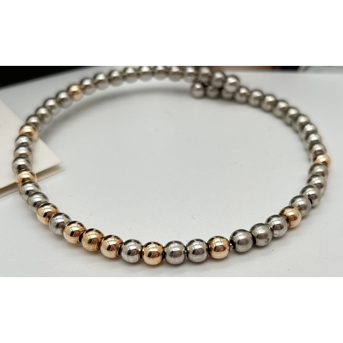 1116 - A boxed Emozioni Hot Diamonds silver and gold plated round bead wrap bracelet. Complete with booklet... 