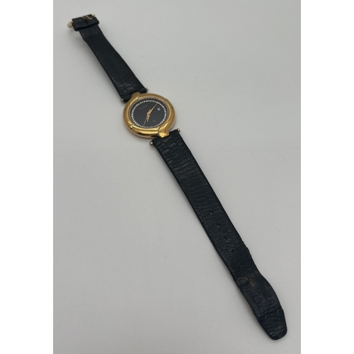 1155 - A ladies vintage wristwatch by Westar with black leather strap and 18ct gold plated twist design cas... 