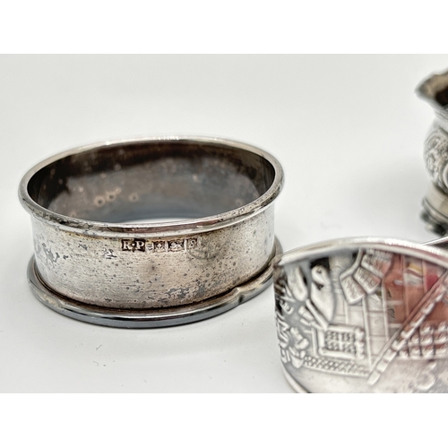 1172 - 3 vintage silver napkin rings. A floral decorated ring with empty cartouche hallmarked 1900, a plain... 