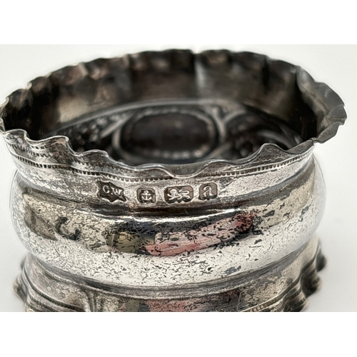 1172 - 3 vintage silver napkin rings. A floral decorated ring with empty cartouche hallmarked 1900, a plain... 