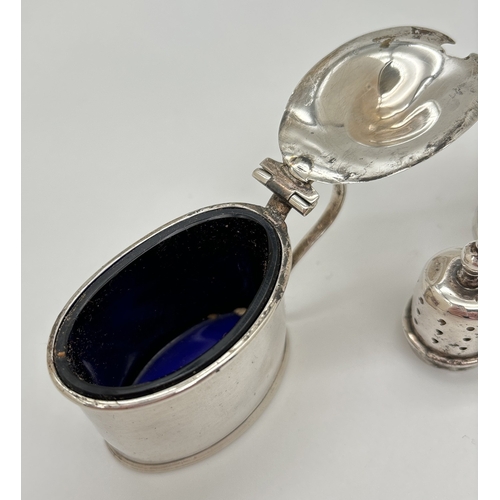 1177 - An Art Deco silver mustard pot and matching pepperette. An antique silver mustard pot of oval shape ... 