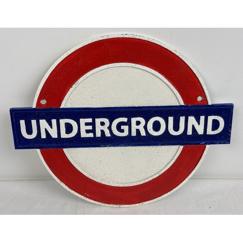 1192 - A cast iron London Underground wall hanging plaque, painted red, white & blue. Approx. 30cm wide.