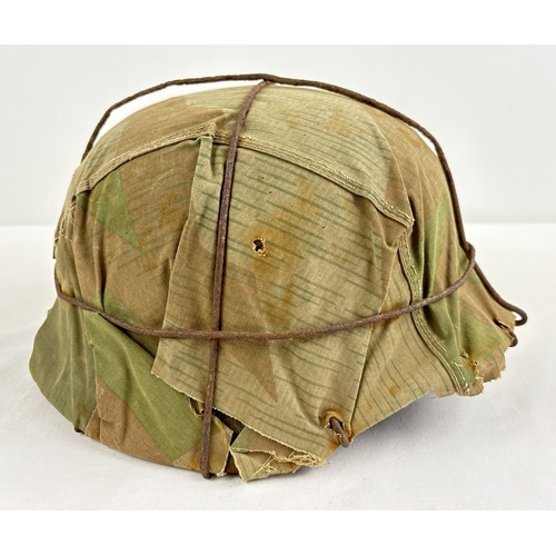 1209 - M40 German steel helmet shell painted field green complete with original camouflage cover and wire c... 