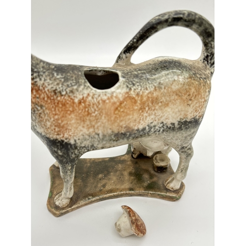 1226 - An Antique Pratt ware creamer in the shape of a cow being milked by a milkmaid. Complete with stoppe... 