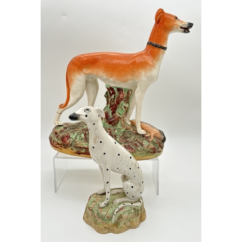 1231 - 2 19th century Staffordshire dog figures. A spotted dalmatian on a naturalistic style base together ... 