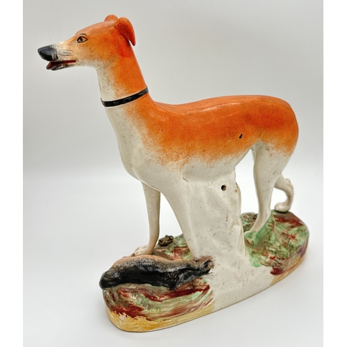 1231 - 2 19th century Staffordshire dog figures. A spotted dalmatian on a naturalistic style base together ... 