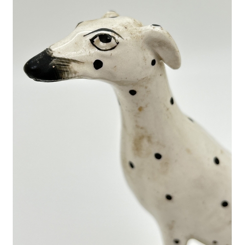 1231 - 2 19th century Staffordshire dog figures. A spotted dalmatian on a naturalistic style base together ... 