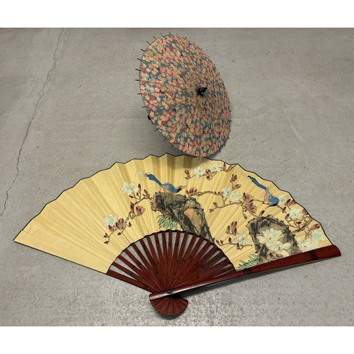 1276 - 2 vintage oriental items. A fabric parasol with carved wooden handle together with a very large deco... 