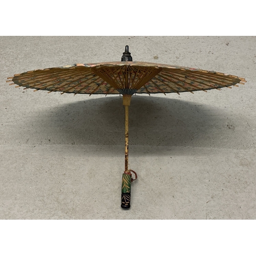 1276 - 2 vintage oriental items. A fabric parasol with carved wooden handle together with a very large deco... 