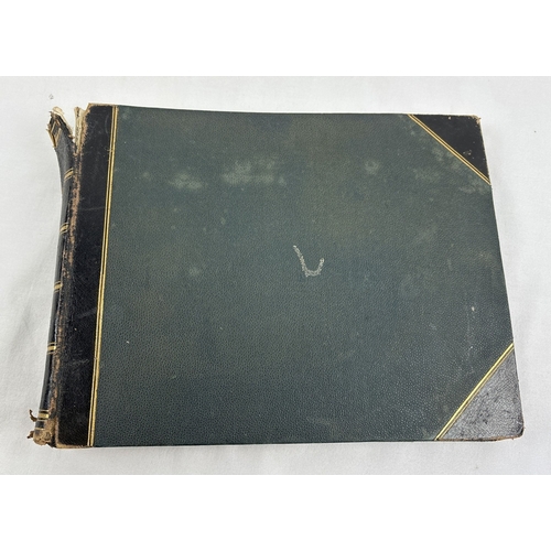 1302 - An antique scrap album with leather spine and corners, containing assorted etchings and coloured pri... 