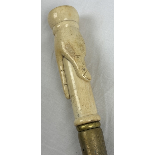 1365 - An ebonised walking cane with carved bone handle modelled as a hand and set with a compass. Approx. ... 