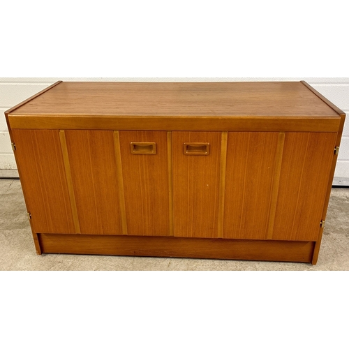 1421 - A retro teak wood low 2 door storage unit with interior sectional compartments and drawer. On caster... 