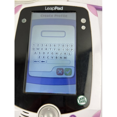 4 - Leapfrog Leap Pad electronic console in pink, with assorted games and accessories. Comes with charge... 