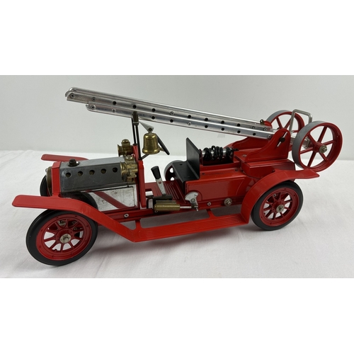 254 - A Mamod FE1 steam powered model fire engine, unboxed, with red body. Approx. 45cm long.