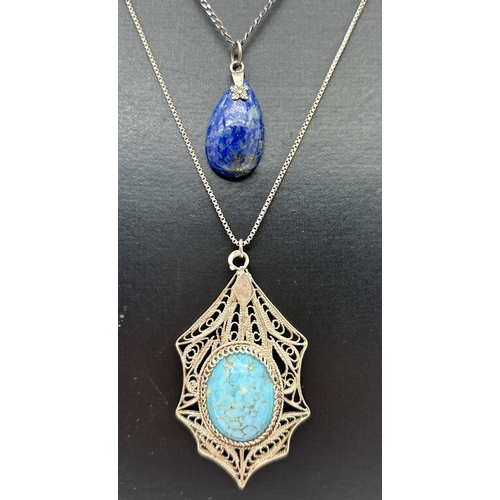 1012 - 2 silver natural stone pendant necklaces. A oval turquoise cabochon set in a filigree mount, on a 20... 