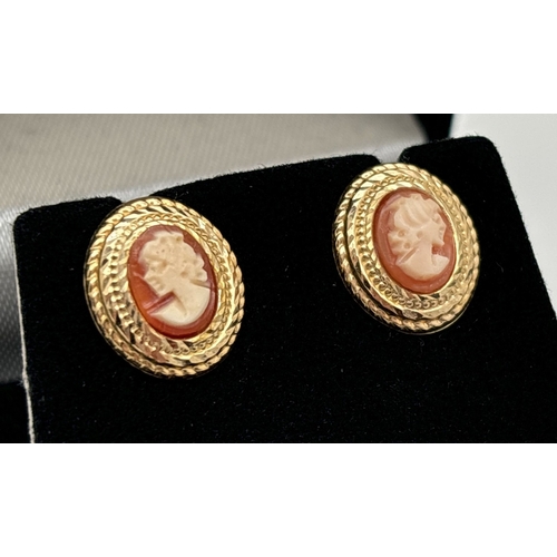 1024 - A boxed Pair of cameo set yellow gold oval stud earrings with butterfly backs. Mount of earrings unm... 