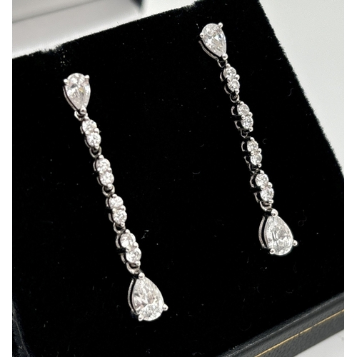 1004 - A pair of 9ct white gold drop earrings each set with 8 small round cut and 2 pear cut cubic zirconia... 