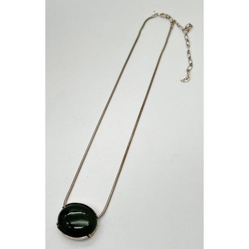 1030 - A Danish silver sliding pendant necklace by Bijou Jeunesse. Oval shaped pendant set with a dark gree... 