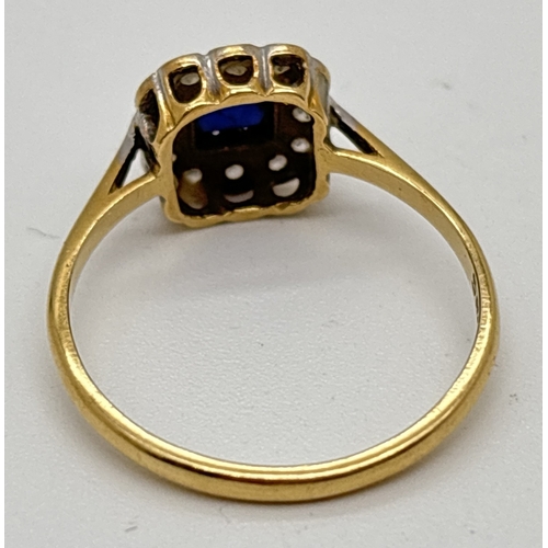 1052 - An 18ct yellow gold, sapphire and diamond square set dress ring. A Central square cut sapphire surro... 