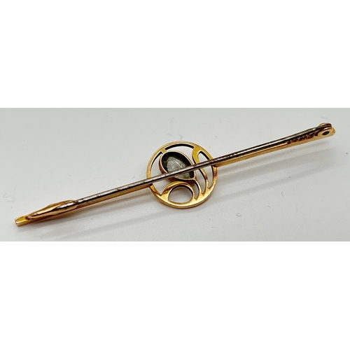 1057 - A vintage 15ct gold bar brooch with central wave design circular panel set with a pear cut Aquamarin... 