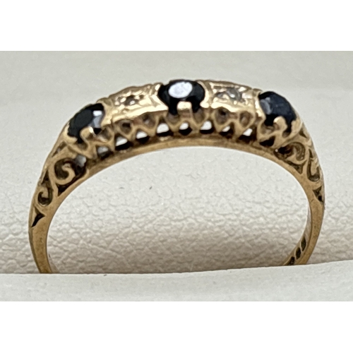 1058 - A vintage 9ct gold sapphire and diamond half eternity ring with scroll detail to shoulders. Size J. ... 