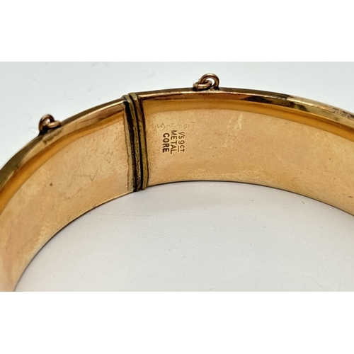 1061 - A vintage 1/5th 9ct gold metal core bangle with half engraved detail of scroll & foliate design. Pus... 