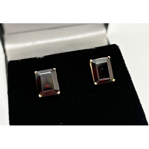 1074 - A pair of large square cut garnet stud earrings with gold mounts & posts. Each stone approx. 12 x 8m... 