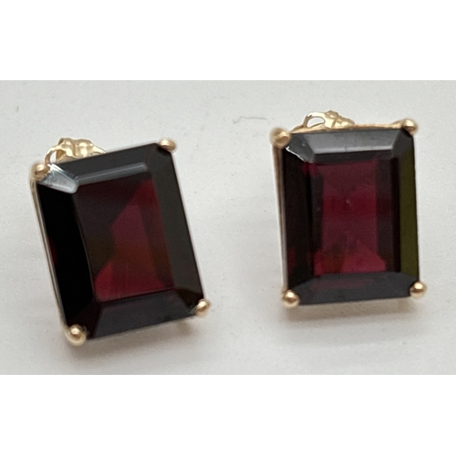 1074 - A pair of large square cut garnet stud earrings with gold mounts & posts. Each stone approx. 12 x 8m... 