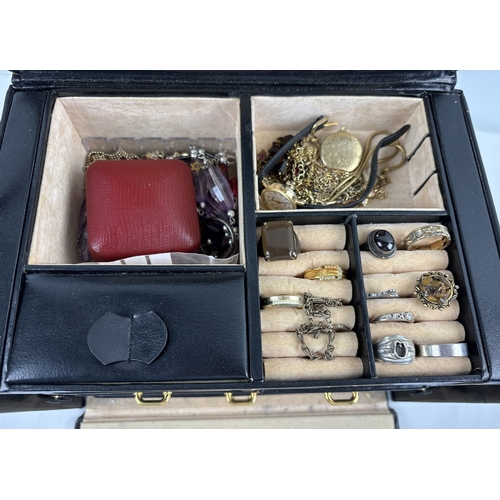 1090 - A large faux leather jewellery box with contents. Jewellery box has ring compartments, 5 pull out tr... 