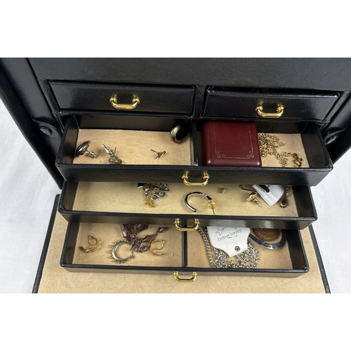 1090 - A large faux leather jewellery box with contents. Jewellery box has ring compartments, 5 pull out tr... 