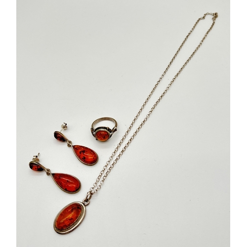 1093 - 3 items of amber set silver jewellery. A pair of double drop earrings, a floral design ring with amb... 