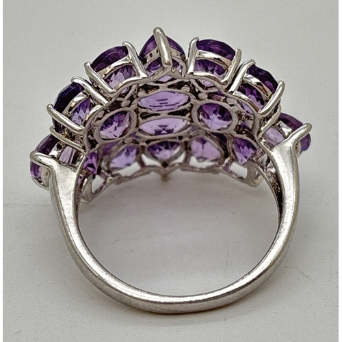 1097 - A large 925 silver statement cocktail ring set with 16 pear and oval cut amethysts. Silver marks ins... 