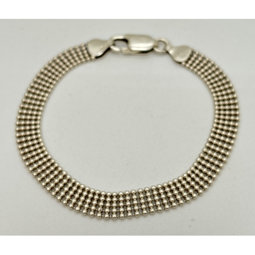 1107 - A silver 7.5 inch 5 row popcorn chain bracelet with lobster claw clasp. Silver marks on fixings and ... 