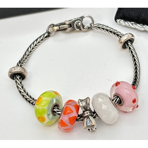 1109 - A boxed Trollbeads charm bracelet with 5 charms and 2 spacer beads. Charms comprise 4 Murano glass c... 