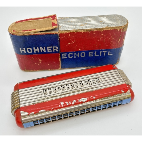 A vintage Echo Elite Harmonica by Hohner in A and D key. With original box. Some flaking to red paintwork. Approx. 14.5cm long.